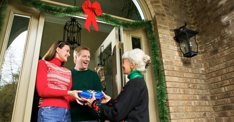 Couple accepting a Christmas gift from their neighbor