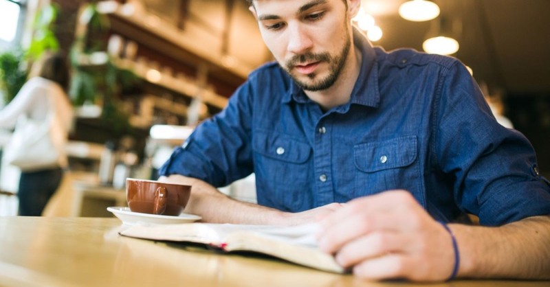 Man studying his Bible at a coffee shop