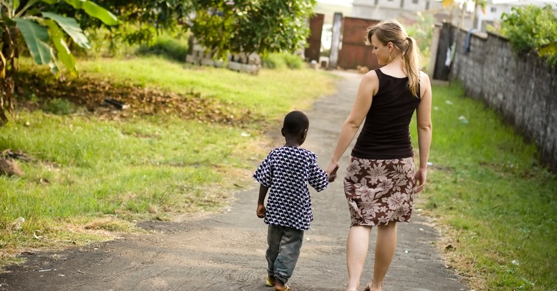 Missionary walking with a young boy