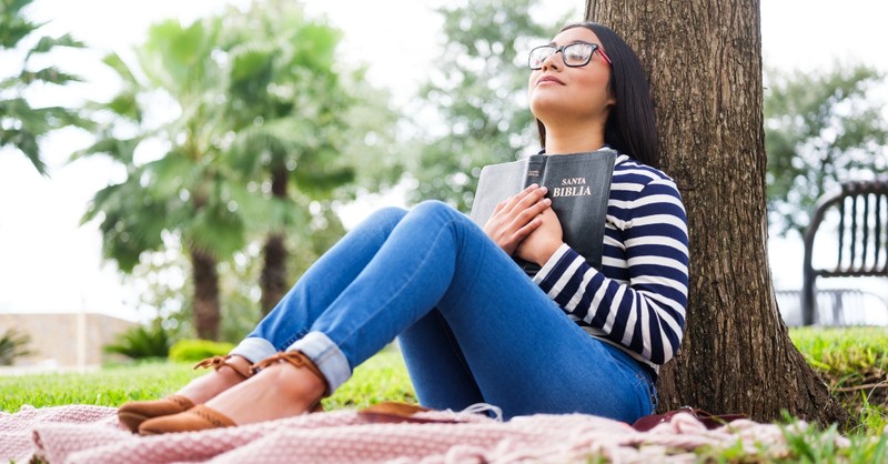 Woman praying with her Bible