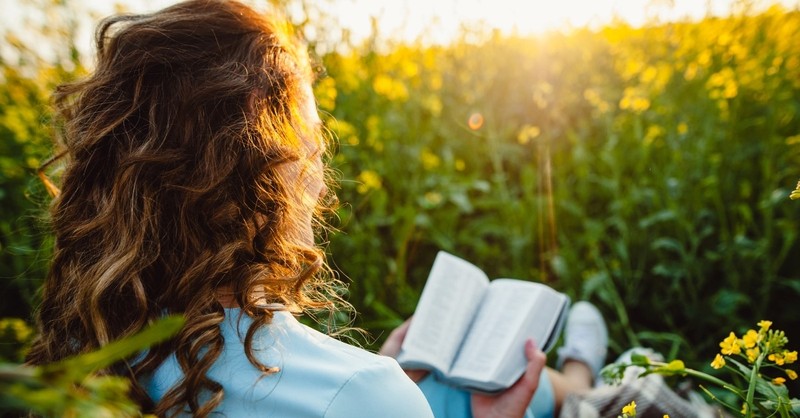 woman in field reading books, max lucado books