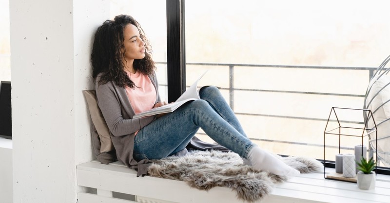 african-american woman sitting by window reading book, Christian romance christian fiction authors