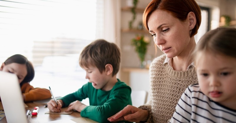 mother doing homeschool work with two children, homeschooling for widows widowers