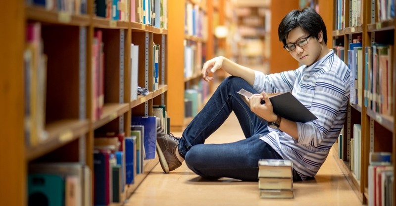 asian student reading books in library, why to study church history