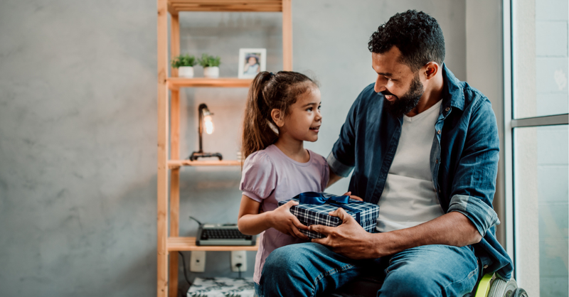 Father and daughter holding a gift