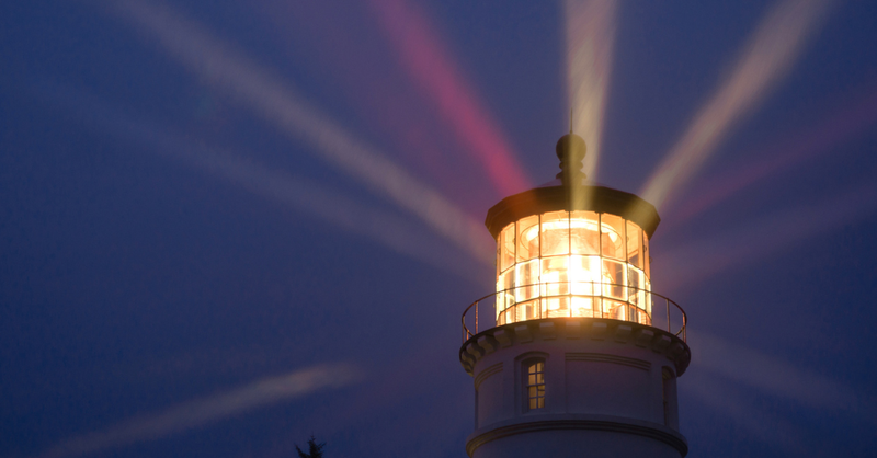 Lighthouse shining at night; shine your light before others.
