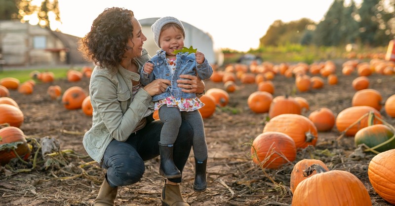 Mom and daughter in a pumpkin patch