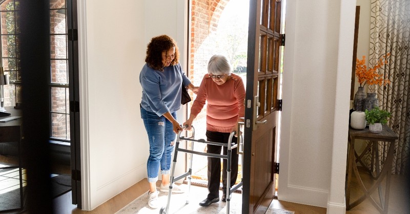 Woman helping an elderly woman