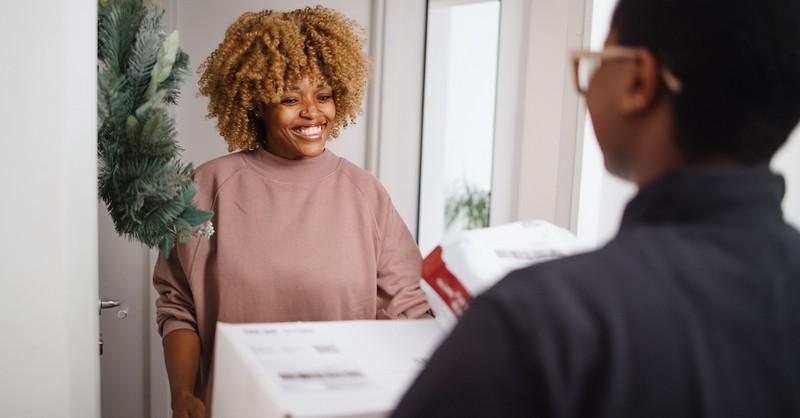 Woman getting delivery packages at door friendly
