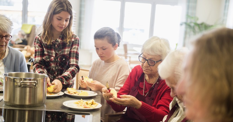 kids helping out at nursing home peeling apples together