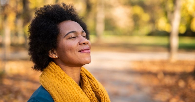 Woman looking grateful and content outside on a fall day