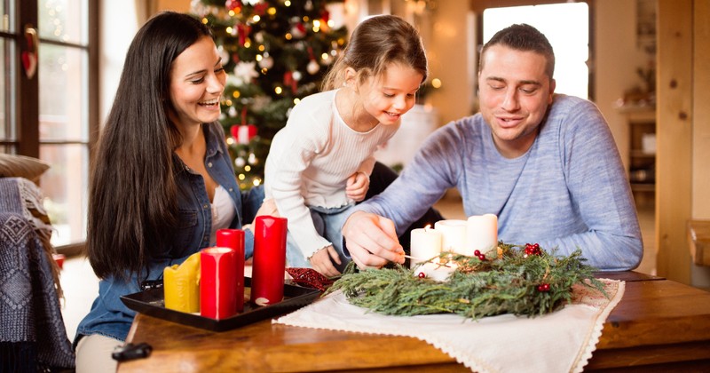 Family lighting an Advent Wreath