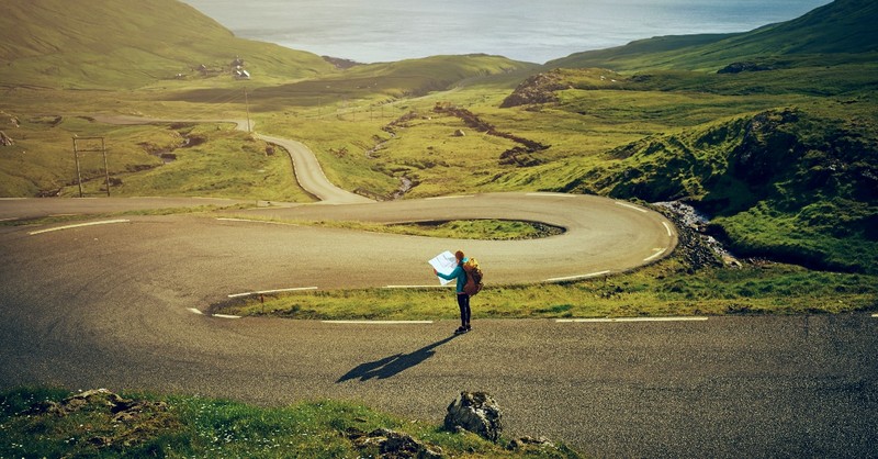 Woman on a road looking at a map