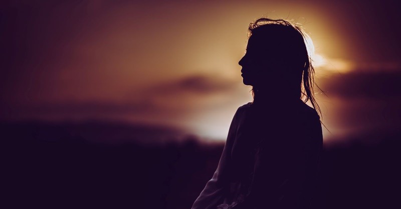 Silhouette of a woman at sunset