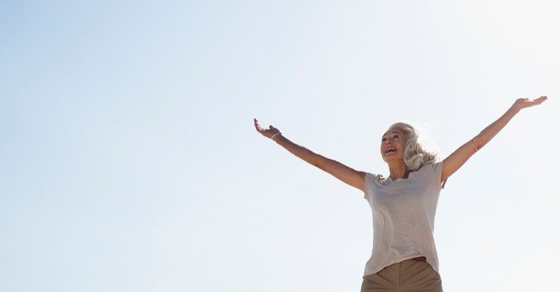 Woman Holding Her Arms Up As If Things Are Fall From The Sky Stock