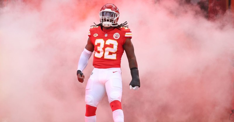 Chiefs defensive player Nick Bolton comes out for a game in a cloud of smoke