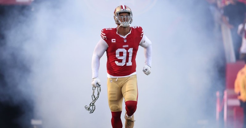 49ers defensive end Arik Armstead comes out for a game amid a cloud of smoke