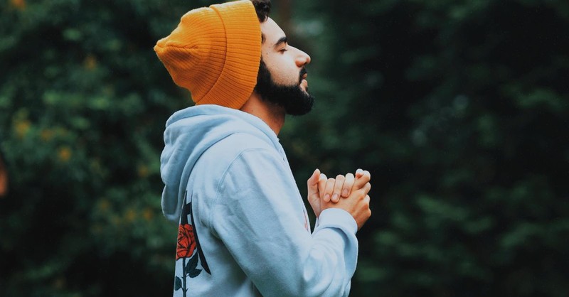 Young man praying outside