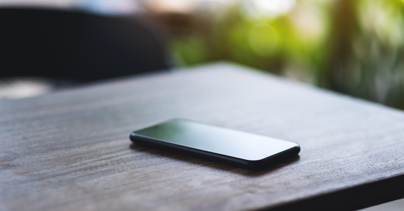 dark phone unused on table outside