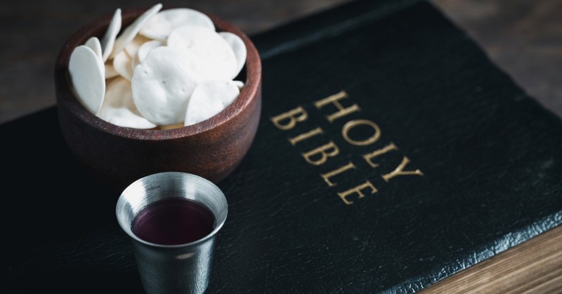 communion wafers and cup on top of holy bible, 5 things christians might get wrong about communion
