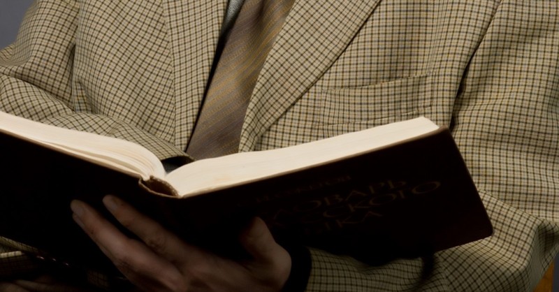 man in tweed reading book, cs lewis christian influencer
