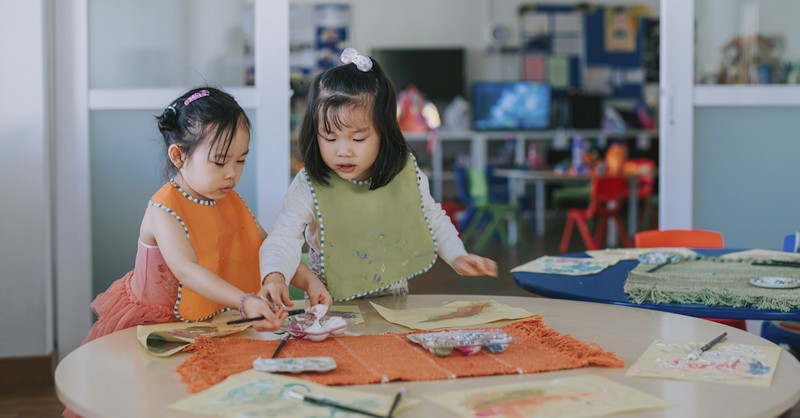 Cute asian sisters drawing painting arts and crafts