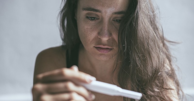Sad woman crying despair grief infertility negative pregnancy test