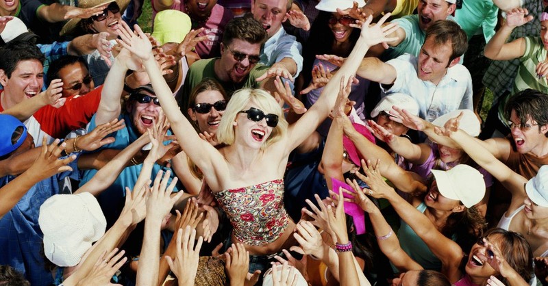 Popular and well-known person of influence being fawned over by a crowd;