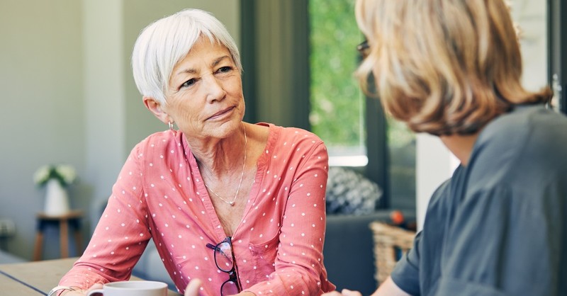 Senior woman mom serious talking with adult child daughter setting boundaries mentor