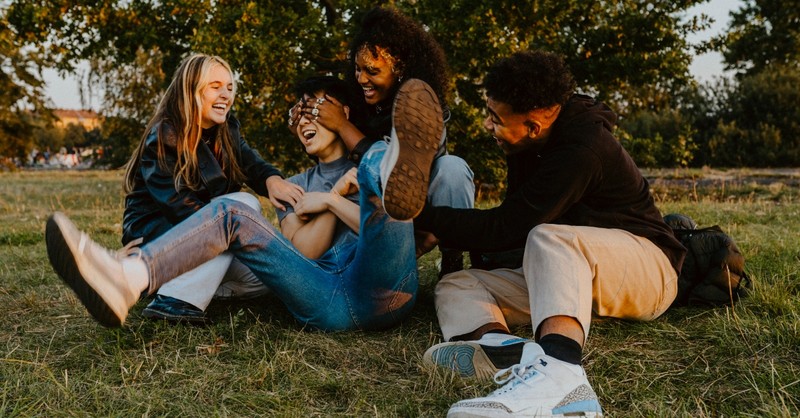 A group of teen friends goofing around in a park