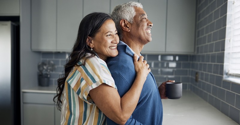 Happy older senior married couple in kitchen