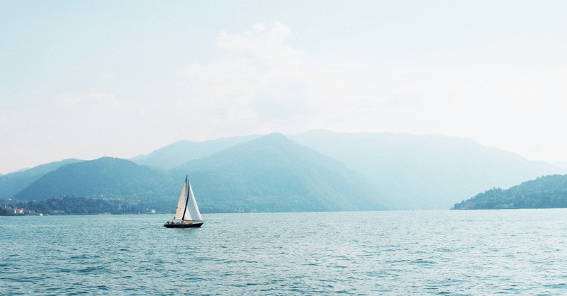 A small sailboat drifting in a lake