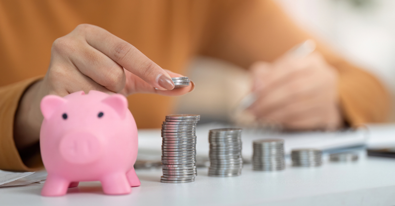 piggy bank with growing stack of coins
