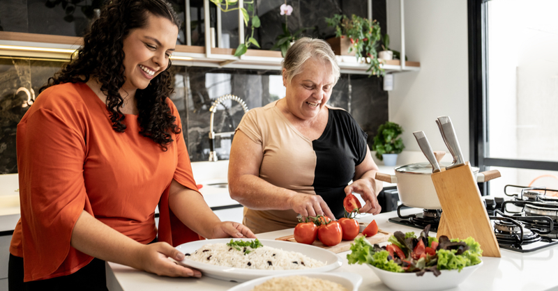 Mother teaching daughter cooking