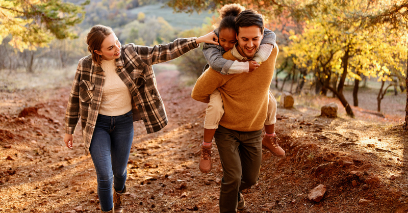 mother, father and children walking autumn