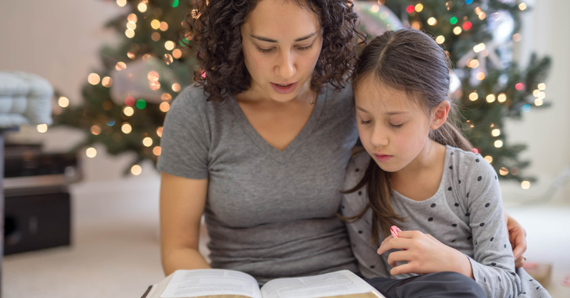 family reading bible christmas