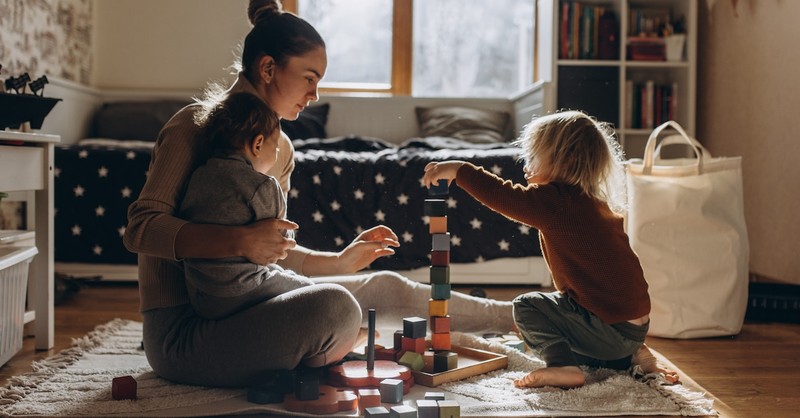 Mom at home playing with toddlers kids children