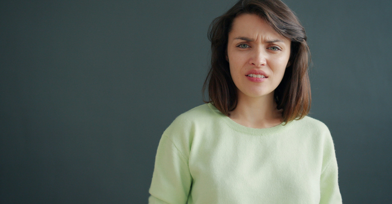 A woman with a confused, questioning expression looks ahead, illustrating the uncertainty, doubt, and frustration many believers experience while learning to trust God's wisdom and timing.