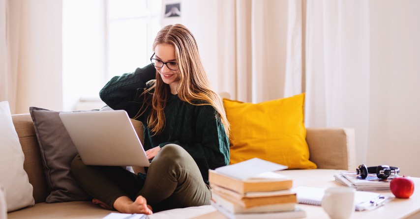 Teen girl sitting on a laptop