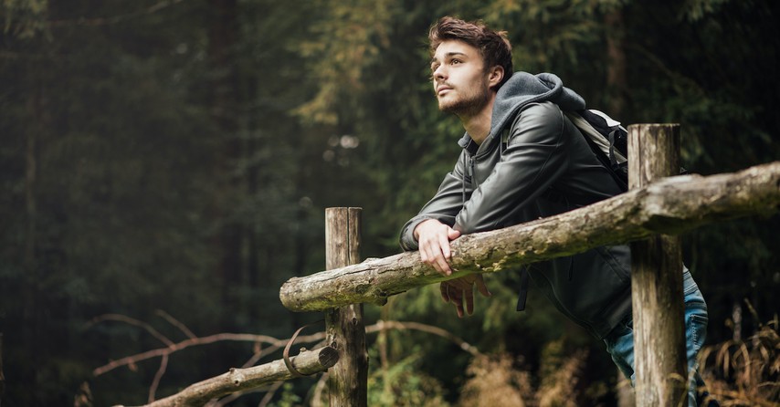 Young man outside looking at nature