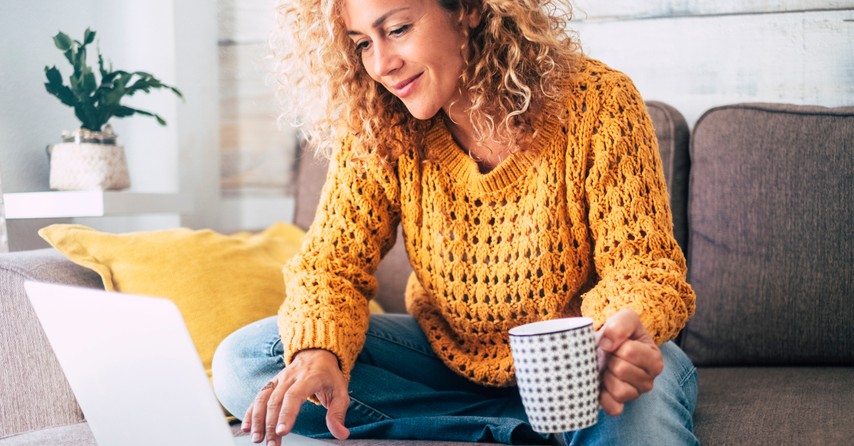 woman watching video on laptop computer happy joy