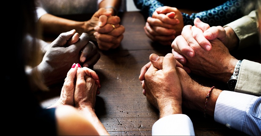 Hands on the table praying