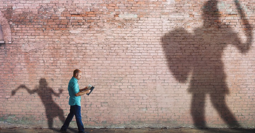 man walking with bible shadows of David with sling and Goliath with shield and sword