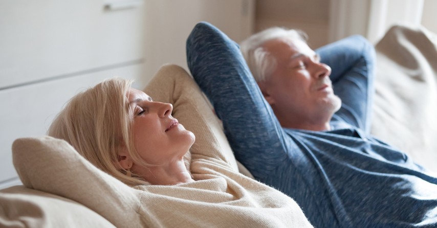 senior couple relaxing on couch happy joyful at peace