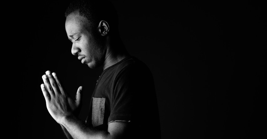 Man bowing head in prayer