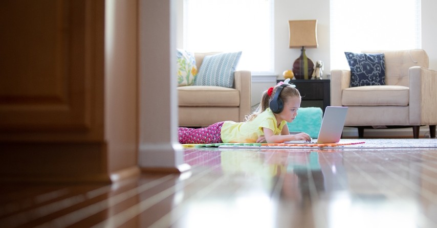 Young girl doing schoolwork on a laptop