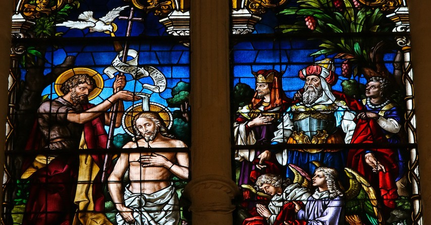 Stained glass window depicting the Baptism of Jesus by Saint John in the cathedral of Burgos, Castille, Spain