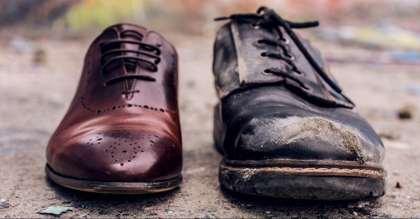 Worn shoe and an expensive new shoe side by side