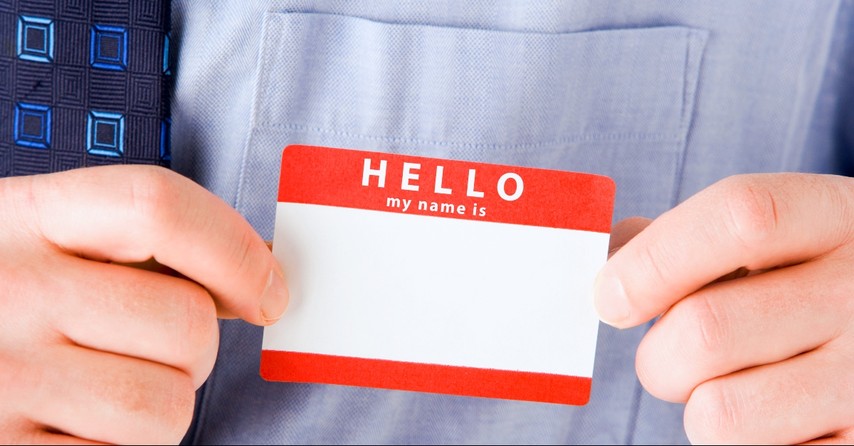 Man holding Hello My Name is name tag, mennonite name game