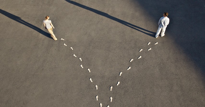 man and woman walking in separate directions